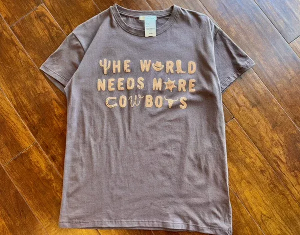 “The World Needs More Cowboys” Graphic Tee